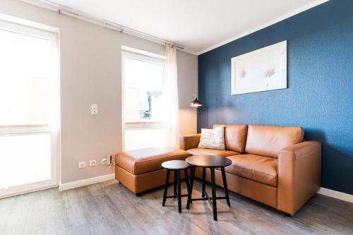a living room with a couch and a table at Fehmarnstrand 78 App 10 in Staberdorf
