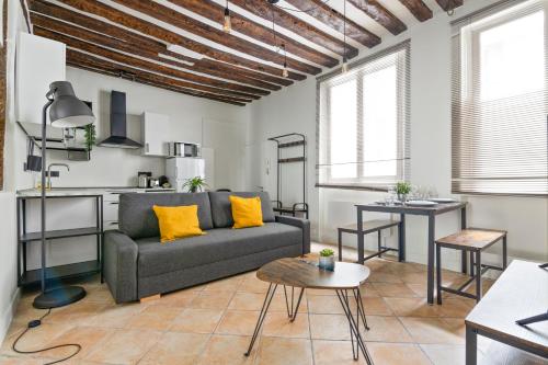 un salon avec un canapé et une table dans l'établissement Heart of Paris - 1BR - 4P - Le Marais 7 Free Netflix, à Paris