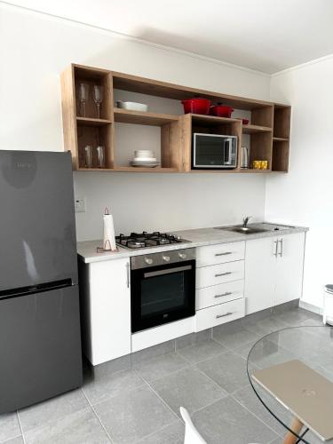 a kitchen with a stainless steel refrigerator and microwave at Sheffield Hills in Ballito