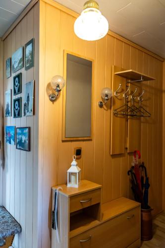 a room with yellow walls and a mirror and a dresser at Ferienwohnung Berg-Glück, ruhige Lage mit Garten in Schmalkalden