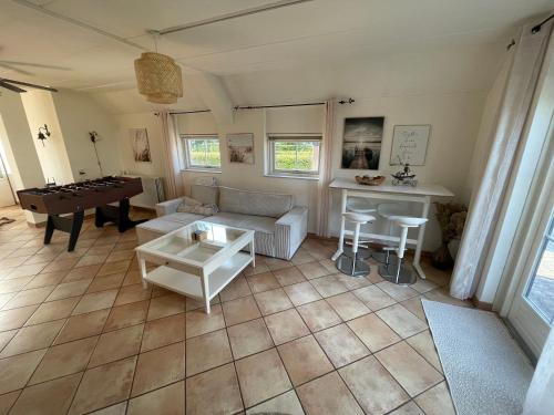 an aerial view of a living room with a couch and a table at Freistehendes Ferienhaus am See Nähe Roermond in Heel