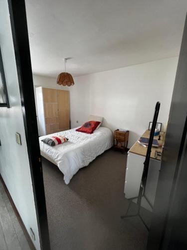 a small bedroom with a bed and a desk at Hôtel de l image in Vouzon