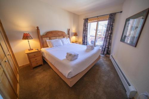 a bedroom with a bed with two towels on it at Tenderfoot Lodge 2620 by SummitCove Lodging in Keystone