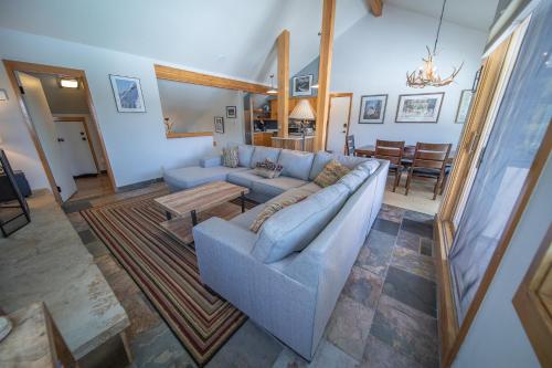 a living room with a couch and a table at Quicksilver 1626 by SummitCove Lodging in Keystone