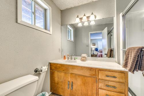 a bathroom with a sink and a mirror at Half-Mi to Midtown Family Retreat with Mtn Views! in Ruidoso