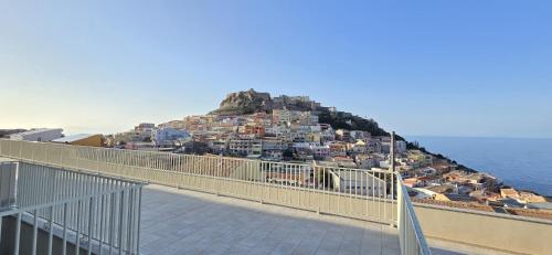 a view of a town on a hill next to the ocean at Residenza Albachiara in Castelsardo