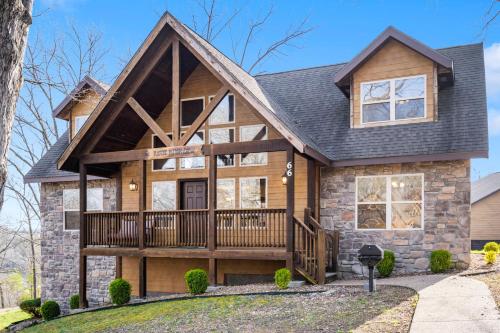 a house with a wrap around porch and a deck at Cozy 'Rustic River Lodge' Near SDC with Pools! in Branson