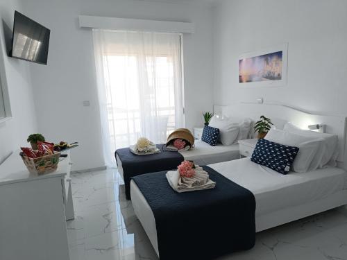 a child sitting on a couch in a living room at Nautilus City Studios & Apartments in Rhodes Town