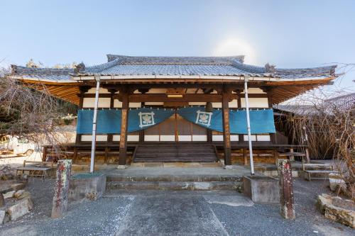 a small building with a blue and white at Temple Hotel Kokushoji 宿坊 国昌寺 in Tsushima