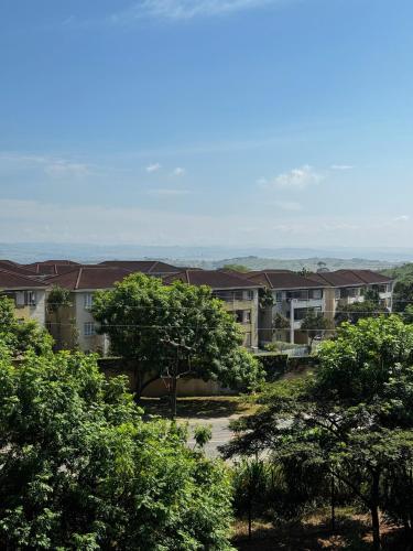 a view of an apartment complex from the trees at Sheffield Hills in Ballito