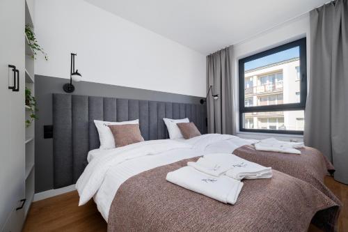 a bedroom with two beds with towels on them at Apartamenty Rocha in Pabianice