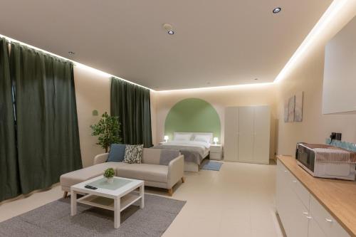 a living room with a bed and a couch at بيتك - Baytak in Al Madinah