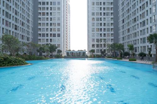 a large pool of blue water with tall buildings at Luxury home in Cibasalen