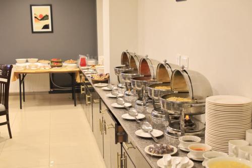 a buffet line with plates and bowls of food at Destination Hotel Murree in Murree