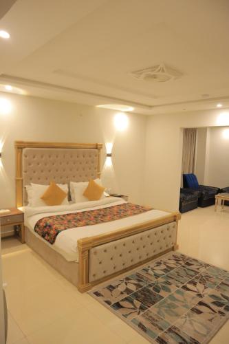 a bedroom with a large bed and a living room at Destination Hotel Murree in Murree