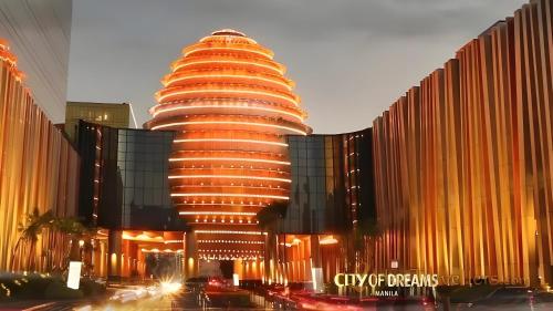 a tall building with a lot of lights on it at Luxury Penthouse & High-Floor Hotel near City of Dreams, Airport, Okada, and Solaire Casino in Manila