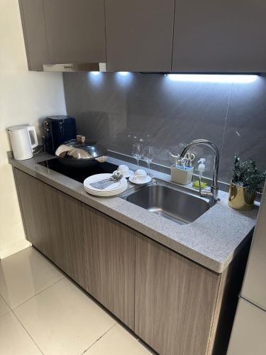 a kitchen with a sink and a counter top at Luxury Penthouse & High-Floor Hotel near City of Dreams, Airport, Okada, and Solaire Casino in Manila