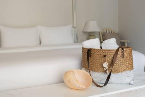 a room with a bed and two bags of towels at O - HO Boutique Home in Baan Tai