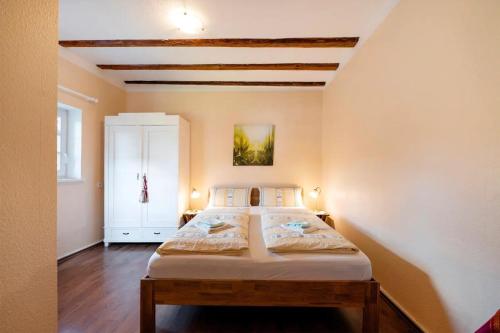a bedroom with a large bed in a room at Kavaliershäuschen - Urlaub auf dem Weingut in Maring-Noviand