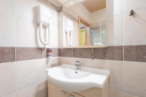 a bathroom with a sink and a mirror at Vila Sofia in Tržič