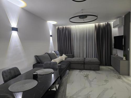 a living room with a couch and a table at Center Park Apartment in Sandanski