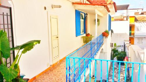 a balcony of a house with a blue railing at Casa Filomena in Ischia