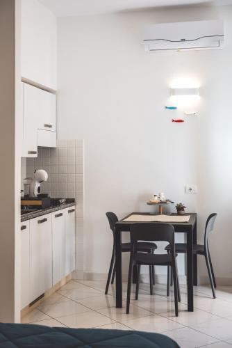 a kitchen with a table and chairs in a room at Camere Margot in Monterosso al Mare