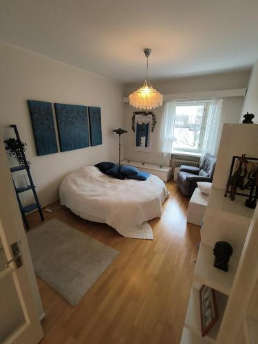 a bedroom with a bed and a living room at Spacious and bright apartment for 4 in Helsinki