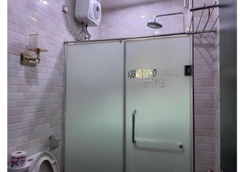 a bathroom with a shower with a toilet in it at Grand Diamond Hotels & Suites LTD in Owerri