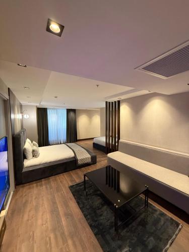 a bedroom with two beds and a piano in it at Nevizade Avangart Hotel in Avcılar