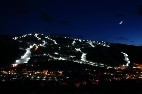 a night view of a mountain with lights on it at Ski Run 201 by SummitCove Lodging in Keystone