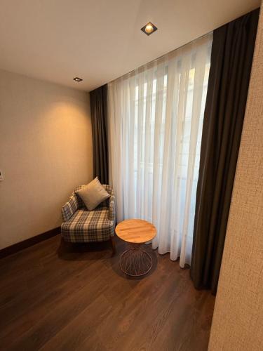 a room with a couch and a table and a window at Nevizade Avangart Hotel in Avcılar