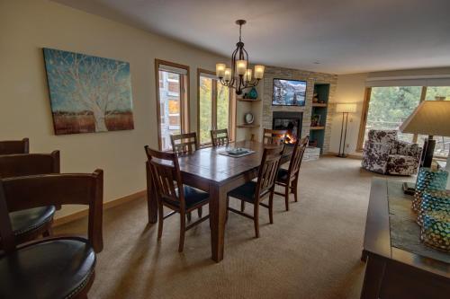 a dining room and living room with a table and chairs at Ski Run 201 by SummitCove Lodging in Keystone