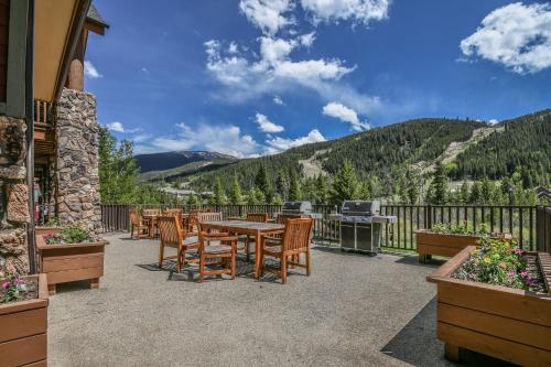 a patio with a table and chairs and a grill at Hidden River Lodge 5981 by SummitCove Lodging in Keystone