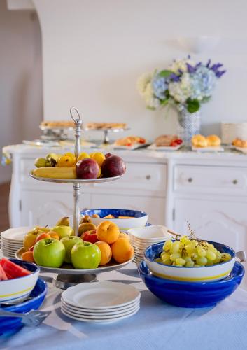 a table topped with plates and bowls of fruit at Hotel Piccolo Sant'Andrea in Praiano