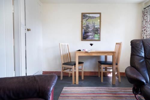 a room with a table and two chairs at Fold Cottage, Outgate near Ambleside in Hawkshead