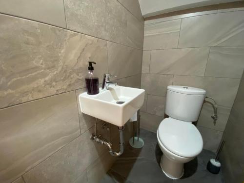 a bathroom with a white toilet and a sink at Mar Menor Golf Resort , La maison bleue, villa piscine privée in Los Martínez