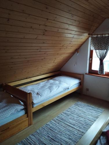 a room with two bunk beds in a attic at Domček u Alina in Žiar
