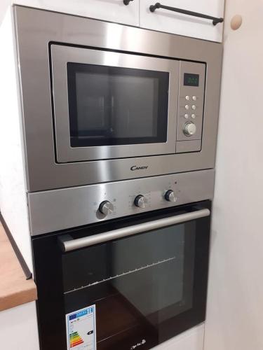 a microwave oven sitting on top of a stove at Statevi Guest Apartment 1 in Velingrad