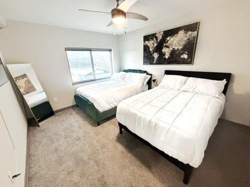 a bedroom with two beds and a window at The Green Onyx Escape in Des Moines