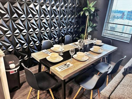 a dining room with a table and chairs at The Green Onyx Escape in Des Moines
