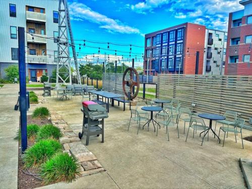 a group of tables and chairs in a courtyard at Cobalt Cove (132) in Des Moines