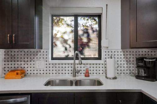 a kitchen counter with a sink and a window at 5 Bedroom Home 10 Min Drive To Downtown in Denver