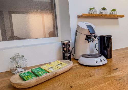 a coffee maker sitting on a counter with a tray of food at Appart avec terrasse, vue & parking - hyper centre in Chartres