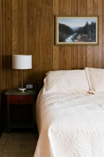a bedroom with a bed and a picture on the wall at Beaver Creek Cabin 1 in Strasburg