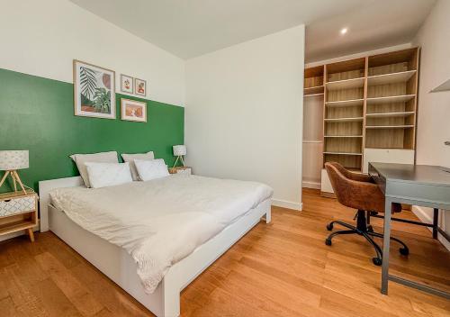 - une chambre avec un lit, un bureau et un ordinateur dans l'établissement Appart avec terrasse, vue & parking - hyper centre, à Chartres