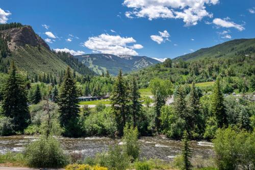 a river in a valley with trees and mountains at Westin #215 B- Hotel in Avon