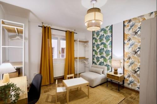 a living room with a couch and a chair at Azpilagaña by Clabao in Pamplona