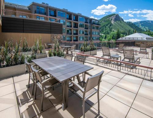 a patio with a table and chairs and a building at Westin #215 A- 1 Bedroom in Avon