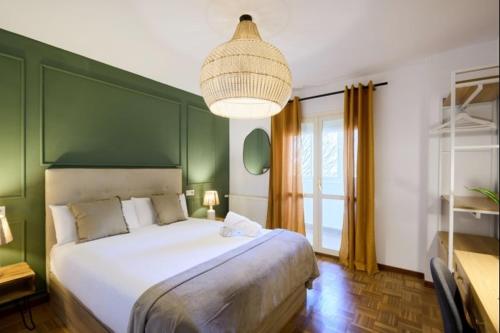 a bedroom with a large bed with a green wall at Azpilagaña by Clabao in Pamplona